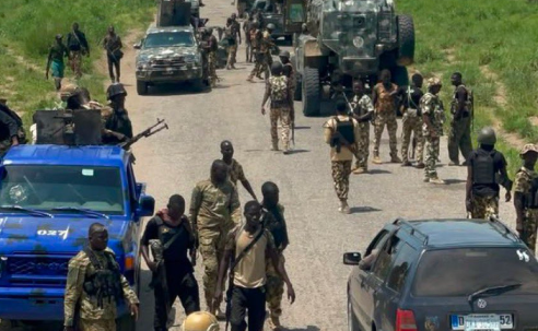 Nigerian troops during a security operation recovering weapons and aiding rescued civilians