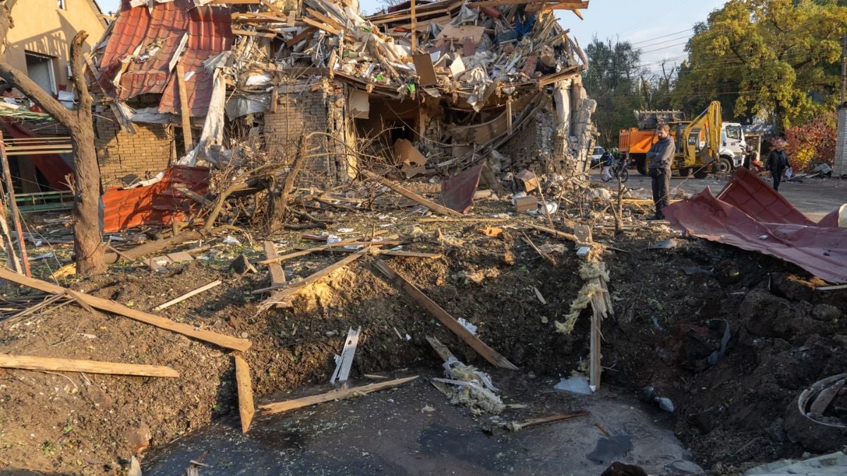 Man views missile crater after Russian air attack in Kharkiv, Ukraine, Oct. 20, 2026